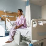Elderly woman patient sitting on a Hospital bed