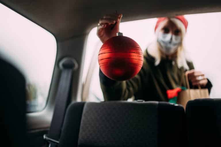 Bauble being held up by masked woman
